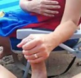Mulher casada batendo punheta pro marido na praia