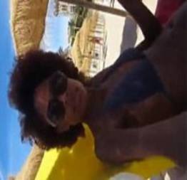 Negra gostosa mostrando os peitinhos e batendo siririca na praia